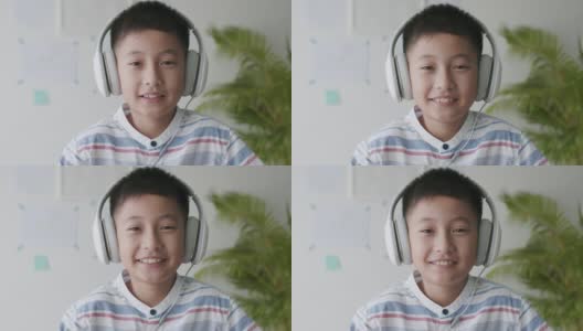 肖像亚洲男孩早上戴着耳机在家快乐的微笑高清在线视频素材下载