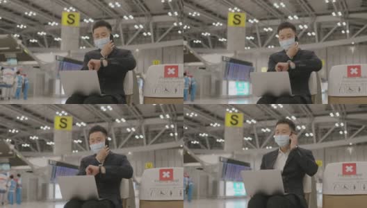 亚洲精力充沛的商人，戴着防护面罩，在等待飞机到达机场期间，接听电话，从合作伙伴那里获得关于新想法的信息-股票视频高清在线视频素材下载