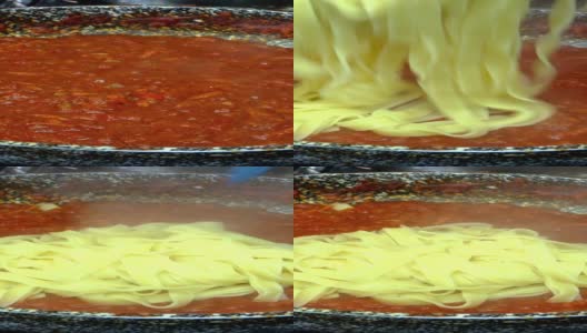 意大利面条加入美味的番茄酱和蔬菜，在煤气炉上的煎锅中慢炖。在家庭厨房里做意大利面或干面条的食谱。高清在线视频素材下载