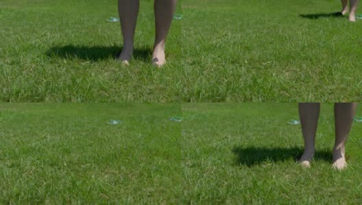 一个人光着脚站在绿草地上，面目全非高清在线视频素材下载
