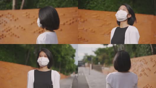 亚洲妇女戴着防护口罩走路高清在线视频素材下载