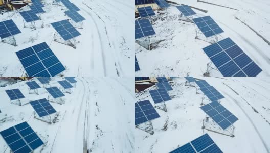 在小型太阳能发电厂，成排的积雪覆盖着太阳能电池板。高清在线视频素材下载