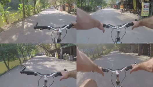 骑自行车穿过越南河滨村高清在线视频素材下载