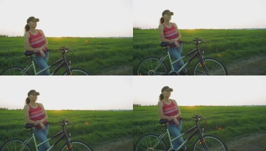 日落时分骑着自行车的女人高清在线视频素材下载