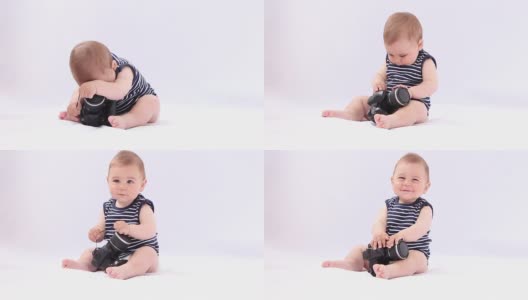 高科技的婴儿。小男孩在玩相机高清在线视频素材下载