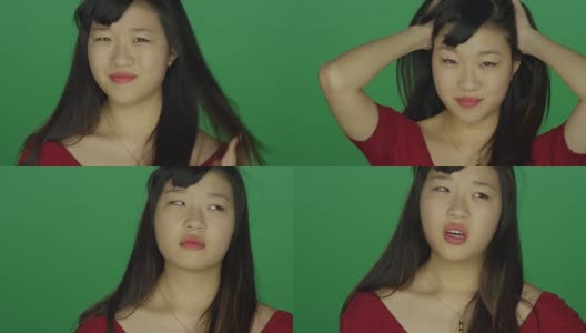一个年轻的亚洲女人看起来非常沮丧和恼怒，在一个绿色屏幕的工作室背景高清在线视频素材下载