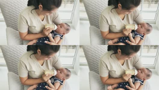 亚洲母亲正在喂她刚出生的男婴高清在线视频素材下载