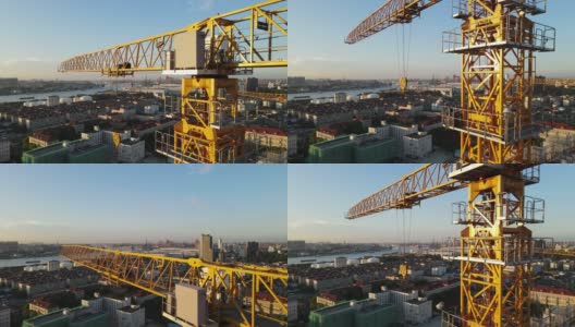 日落时分，无人机在工地吊车塔周围向上移动高清在线视频素材下载