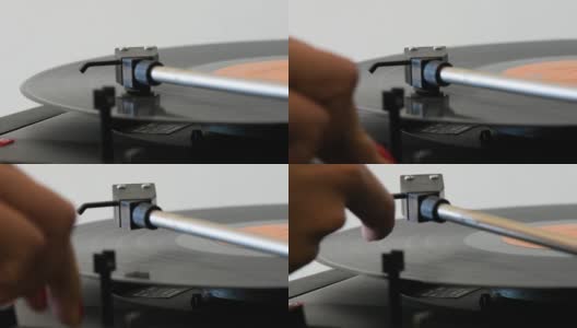 旋转黑胶唱片被一个女人的手关闭。高清在线视频素材下载