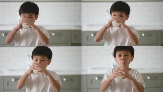 亚洲小孩早餐喝一杯牛奶。健康早餐的概念高清在线视频素材下载