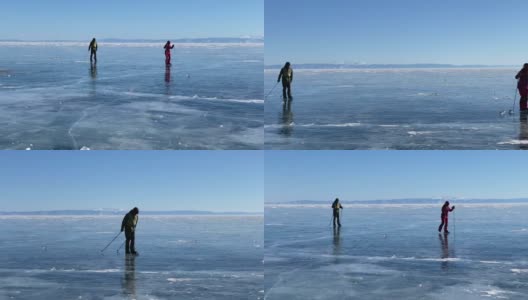在贝加尔湖上滑冰。一个男孩和一个女孩拿着滑雪杖在结冰的贝加尔湖上滑冰。高清在线视频素材下载