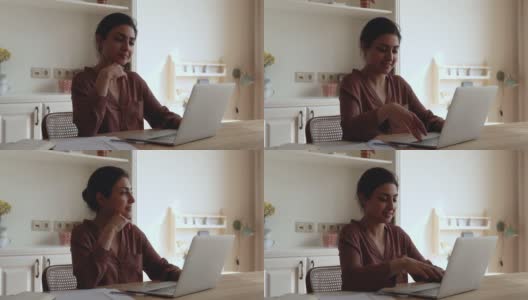 沉思的印度千禧一代女性在笔记本电脑上上网高清在线视频素材下载