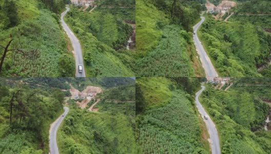 鸟瞰图:一辆汽车在群山、绿色森林、丛林和岩石之间行驶高清在线视频素材下载