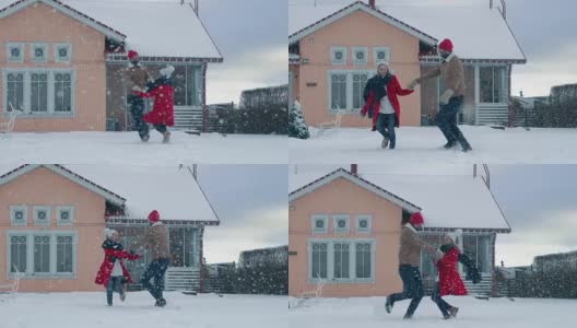 年轻美丽的夫妇在飘落的雪中跳舞和旋转。快乐的男人和女人在他们田园诗般的房子的院子里玩耍。高清在线视频素材下载