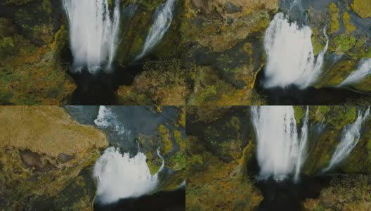 冰岛美丽的Gljufrabui瀑布鸟瞰图。一架直升机飞过一股水流，从悬崖上落下高清在线视频素材下载