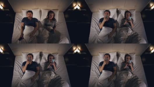 一个男人和一个女人在床上看书的特写。4 k。高清在线视频素材下载
