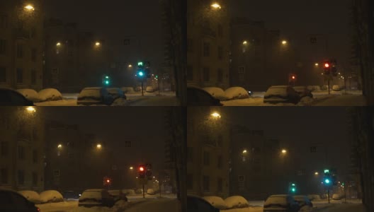 城市晚上下大雪。雪花照灯落在路上高清在线视频素材下载