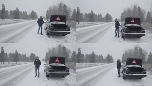 那个人寻求帮助，车子在冬天的路上抛锚了。试图拦住一辆过路的汽车。高清在线视频素材下载