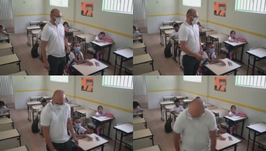 老师戴着口罩帮助残疾学生高清在线视频素材下载