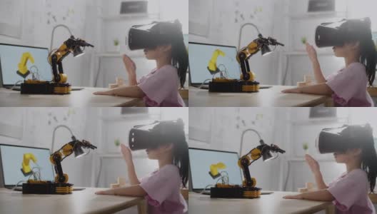 女孩在VR眼镜上控制机器人手臂，在高中上机器人课高清在线视频素材下载
