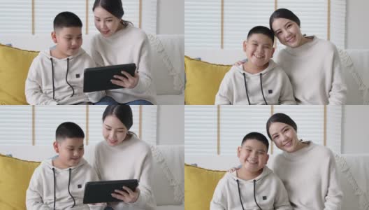 Portrait亚洲家庭妈妈和儿子孩子在家里学习在平板电脑上。高清在线视频素材下载