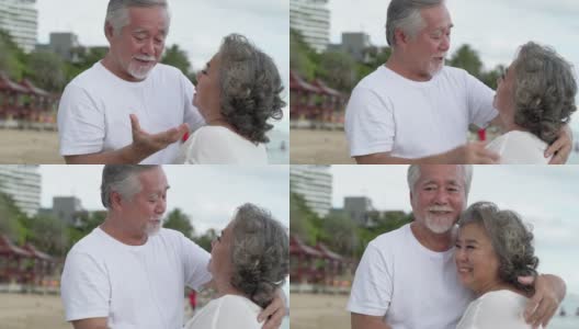 上了年纪的亚洲夫妇说，爱情就像昨天一样，他们在浪漫的海边亲吻拥抱。高清在线视频素材下载