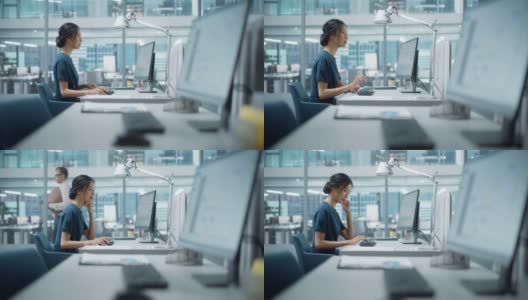 在大多样化的公司办公室:美丽的亚洲经理肖像使用台式电脑，女商人管理公司运营，分析统计，商业数据，营销计划。高清在线视频素材下载