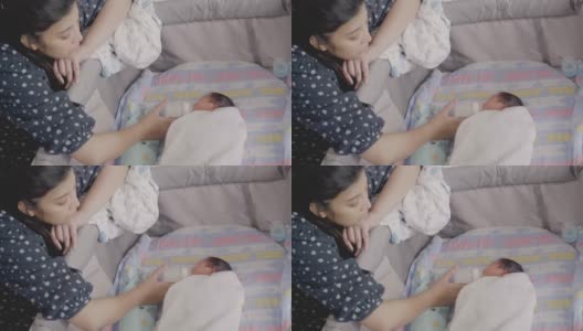 亚洲母亲正在给婴儿喂奶。高清在线视频素材下载