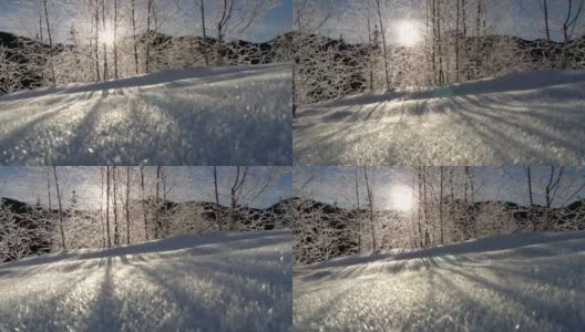 阳光透过冰冻的树木照射进来。日出在山上。平衡稳定拍摄高清在线视频素材下载