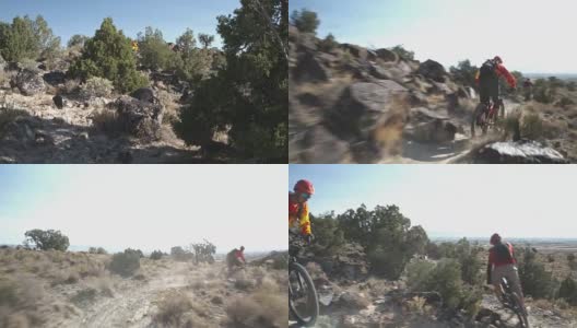 两个男人骑着山地车爬上沙漠中的岩石高清在线视频素材下载