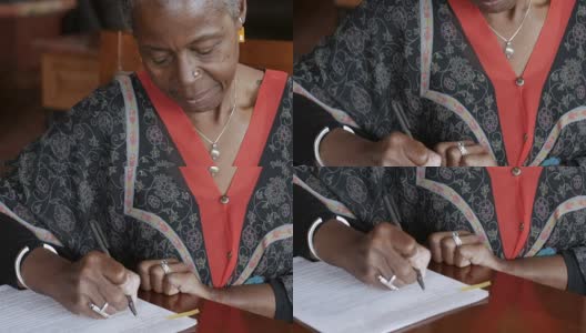 黑人老年妇女在法律文书上签名高清在线视频素材下载