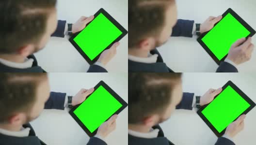 一名男子使用绿色屏幕的数字平板电脑高清在线视频素材下载