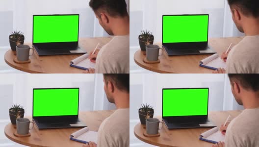 用模拟色度键显示的个人电脑做笔记的人高清在线视频素材下载