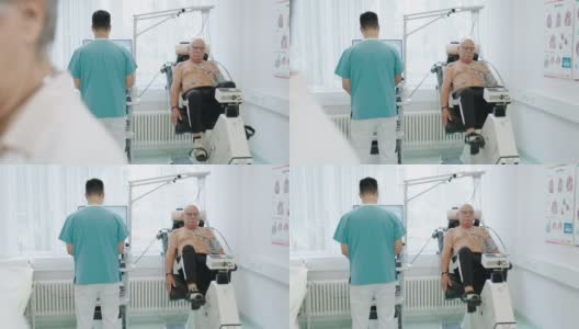 老年男性患者在静态自行车上进行心脏压力测试高清在线视频素材下载
