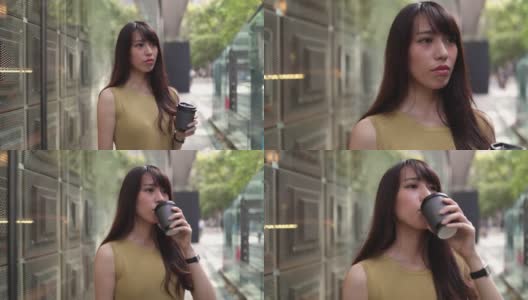 城市里穿黄衣服的女人在喝咖啡高清在线视频素材下载