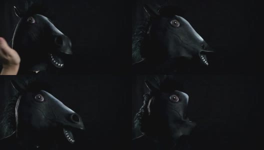 在黑色背景的慢动作中，用手捂住马的面具高清在线视频素材下载