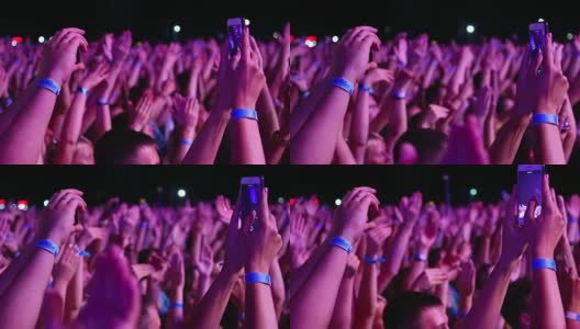 手持智能手机观看摇滚音乐会的观众高清在线视频素材下载