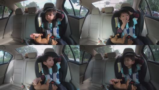 可爱的男孩坐在汽车座椅上高清在线视频素材下载