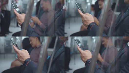 商人在乘坐地铁期间使用智能手机，特写高清在线视频素材下载