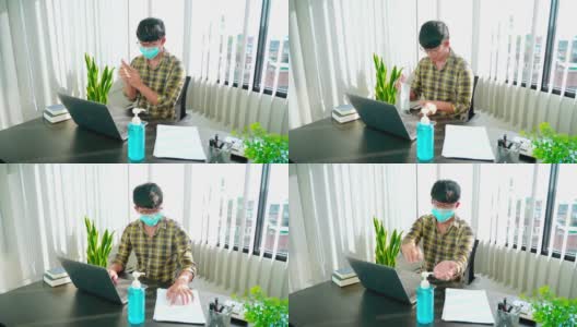 “商人佩戴防护口罩、使用洗手液在办公室工作杀灭covid-19、预防感染和大流行”的4k视频画面高清在线视频素材下载