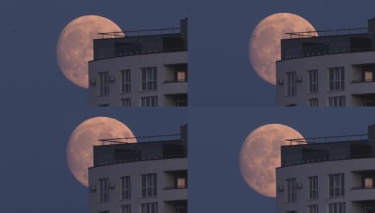 上升的满月穿过屋顶。高清在线视频素材下载