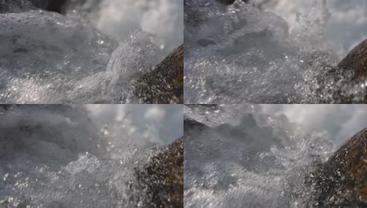 近距离拍摄纯净的山涧水从融雪的岩石上落下高清在线视频素材下载