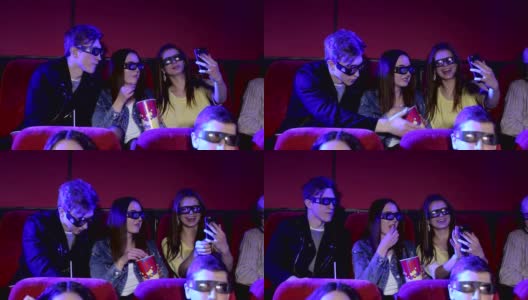 年轻有趣的青少年戴着3D眼镜在电影院自拍。高清在线视频素材下载