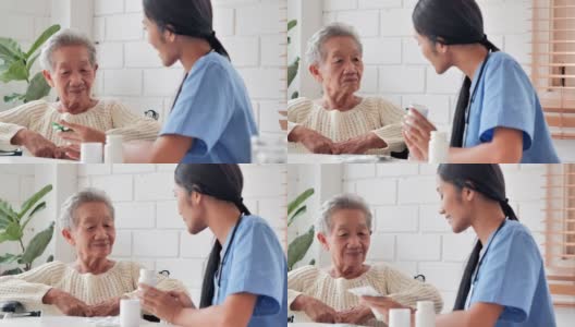亚洲老年妇女听年轻的黑人女护士医生解释药物给她年长的女性病人在家。采购产品医疗，护理，护理，退休，志愿者，慈善，教育，养老院，在家照顾者，医药和卫生保健高清在线视频素材下载