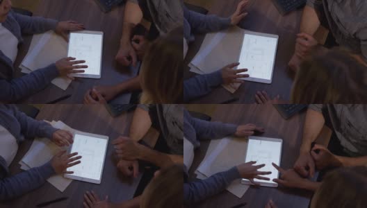近距离拍摄一位面目全非的女销售员在平板电脑上一边说话一边展示房子的蓝图高清在线视频素材下载
