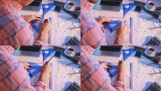 一名男建筑师在他的办公桌上绘制蓝图高清在线视频素材下载