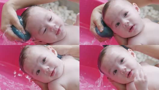 在浴缸里洗澡的亚洲婴儿高清在线视频素材下载