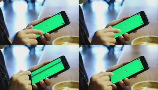 近距离的女人拿着手机与标记绿色屏幕幻灯片屏幕在咖啡店的桌子上高清在线视频素材下载