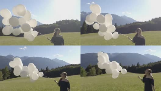 女孩在风中拿着白色的气球高清在线视频素材下载