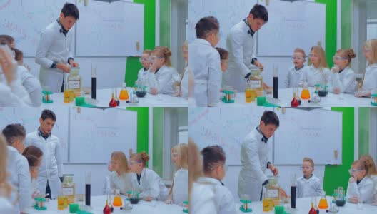 年轻的男孩和女孩们正在做化学实验。老师和小朋友在上化学课高清在线视频素材下载
